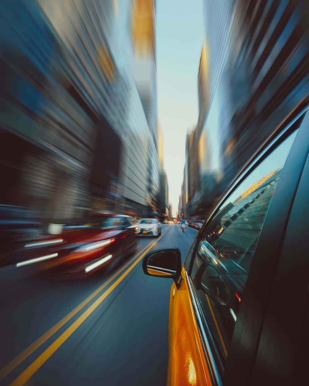 panning photo of yellow car